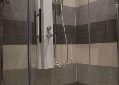 rivestimento box doccia con piastrelle in gres diversi colori di grigio